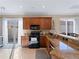 Modern kitchen with granite counters, stainless steel appliances, and breakfast bar at 482 Montelluna Dr, North Venice, FL 34275