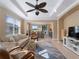 Spacious living room with a ceiling fan, comfy seating, and a view of the dining area at 482 Montelluna Dr, North Venice, FL 34275