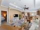 Open concept living space with comfortable seating, a large TV, and a view of the kitchen at 482 Montelluna Dr, North Venice, FL 34275