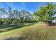 Open backyard with a canal view and lush green grass at 507 Foxwood Blvd # 4, Englewood, FL 34223