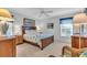 Bedroom with wood furniture and coastal bedding at 507 Foxwood Blvd # 4, Englewood, FL 34223