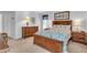 Cozy bedroom with wood frame bed and neutral decor at 507 Foxwood Blvd # 4, Englewood, FL 34223