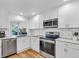 Modern kitchen with stainless steel appliances and white cabinets at 507 Foxwood Blvd # 4, Englewood, FL 34223