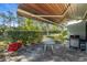 Relaxing patio with a table, chairs, and grill, overlooking a yard at 507 Foxwood Blvd # 4, Englewood, FL 34223