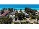 Aerial view showing beachfront community, tennis court, and pool at 5125 Gulf Of Mexico Dr # 7, Longboat Key, FL 34228