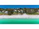 Aerial view of beachfront property with pool and lush landscaping at 5125 Gulf Of Mexico Dr # 7, Longboat Key, FL 34228