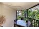 Screened balcony with patio furniture and ocean view at 5125 Gulf Of Mexico Dr # 7, Longboat Key, FL 34228