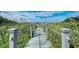 Wooden boardwalk leads to the beach, offering a scenic pathway at 5125 Gulf Of Mexico Dr # 7, Longboat Key, FL 34228