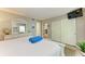 Bedroom with queen bed, dresser, and access to another room at 5125 Gulf Of Mexico Dr # 7, Longboat Key, FL 34228