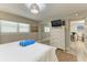 Bedroom with full bed, dresser and view into dining area at 5125 Gulf Of Mexico Dr # 7, Longboat Key, FL 34228