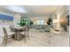 Open dining room with light wood table and coastal decor at 5125 Gulf Of Mexico Dr # 7, Longboat Key, FL 34228