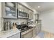 Modern kitchen with granite countertops and stainless steel appliances at 5125 Gulf Of Mexico Dr # 7, Longboat Key, FL 34228