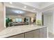 Open kitchen with granite countertops and a view into living room at 5125 Gulf Of Mexico Dr # 7, Longboat Key, FL 34228