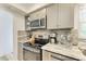 Modern kitchen with stainless steel appliances and granite countertops at 5125 Gulf Of Mexico Dr # 7, Longboat Key, FL 34228