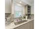 Kitchen sink and counter with granite countertop and stainless steel faucet at 5125 Gulf Of Mexico Dr # 7, Longboat Key, FL 34228