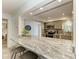 Open kitchen with breakfast bar and granite countertops at 5125 Gulf Of Mexico Dr # 7, Longboat Key, FL 34228