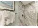 Walk-in shower with marble tile and modern fixtures at 5125 Gulf Of Mexico Dr # 7, Longboat Key, FL 34228