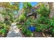 Landscaped walkway with lush tropical plants at 5125 Gulf Of Mexico Dr # 7, Longboat Key, FL 34228