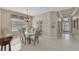 Dining room with glass table and six chairs, view of entryway at 5704 Whispering Oaks Dr, North Port, FL 34287