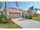 Well-maintained house with a two-car garage and attractive landscaping at 5704 Whispering Oaks Dr, North Port, FL 34287