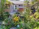 Private backyard featuring a hot tub, lush tropical landscaping, and a charming patio area at 601 E Seminole Dr, Venice, FL 34293