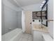 Clean bathroom with gray tile, a bathtub, and a vanity with a mirror at 601 E Seminole Dr, Venice, FL 34293