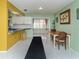 Open dining area with seamless transition into kitchen space and ample natural lighting at 601 E Seminole Dr, Venice, FL 34293