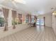 Bright Florida room with tile flooring, ceiling fans, and views of the pool and greenery at 601 E Seminole Dr, Venice, FL 34293