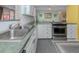 Modern kitchen with sleek stainless steel appliances and a double sink at 601 E Seminole Dr, Venice, FL 34293