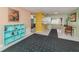 Open-concept living space with a book shelf and a breakfast bar in the connecting kitchen at 601 E Seminole Dr, Venice, FL 34293