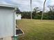 Large grassy backyard with mature trees, offering privacy at 607 Cervina Dr, Venice, FL 34285