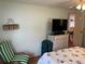 Bedroom with a striped chair and dresser at 607 Cervina Dr, Venice, FL 34285