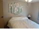 Bedroom with a queen-size bed, wall art, and a ceiling fan at 607 Cervina Dr, Venice, FL 34285