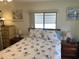 Bedroom with bed, nightstands, and window at 607 Cervina Dr, Venice, FL 34285