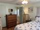 Bedroom with dresser, ensuite bathroom and bed at 607 Cervina Dr, Venice, FL 34285