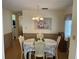 Formal dining room features a round table with seating for four and wood floors at 607 Cervina Dr, Venice, FL 34285
