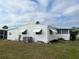 Rear view of a white manufactured home with awnings at 607 Cervina Dr, Venice, FL 34285