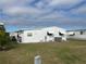 Side view of a white manufactured home, showing AC unit at 607 Cervina Dr, Venice, FL 34285