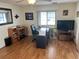 Bright home office featuring a desk, shelving, and wood floors at 607 Cervina Dr, Venice, FL 34285