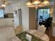 Clean kitchen with white cabinets and view into living area at 607 Cervina Dr, Venice, FL 34285