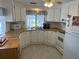 Bright kitchen features wood laminate counters, white cabinets, and a built-in microwave at 607 Cervina Dr, Venice, FL 34285