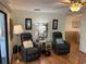 Relaxing living room with two comfy leather recliners and wood flooring at 607 Cervina Dr, Venice, FL 34285