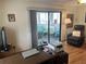 Bright living room with sliding doors leading to a sunroom at 607 Cervina Dr, Venice, FL 34285