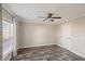 Simple bedroom with wood-look floors, ceiling fan and window at 6281 Oriole Blvd, Englewood, FL 34224