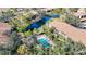 Community pool and surrounding buildings from above at 654 Bird Bay E Dr # 206, Venice, FL 34285