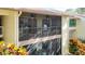 Spacious screened balcony with dual ceiling fans and comfortable seating; perfect for relaxing outdoors at 654 Bird Bay E Dr # 206, Venice, FL 34285