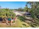 Backyard oasis with a large screened enclosure, fire pit, and lush landscaping at 690 Percheron, Nokomis, FL 34275