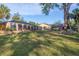 Spacious backyard with a large screened enclosure and a grassy lawn at 690 Percheron, Nokomis, FL 34275