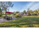 Backyard patio with seating area and a large, lush lawn at 690 Percheron, Nokomis, FL 34275