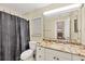 Bathroom with granite countertop, shower/tub combo and gray shower curtain at 690 Percheron, Nokomis, FL 34275